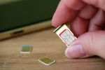 person-holding-sim-card-into-600nw-2303297517.webp
