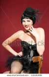 stock-photo-burlesque-pin-up-woman-with-black-hair-dressed-in-black-sexy-pose-sitting-on-chai...webp