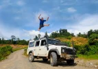 Man-Jumping-On-Top-Of-4x4-Car-In-Celebration.webp